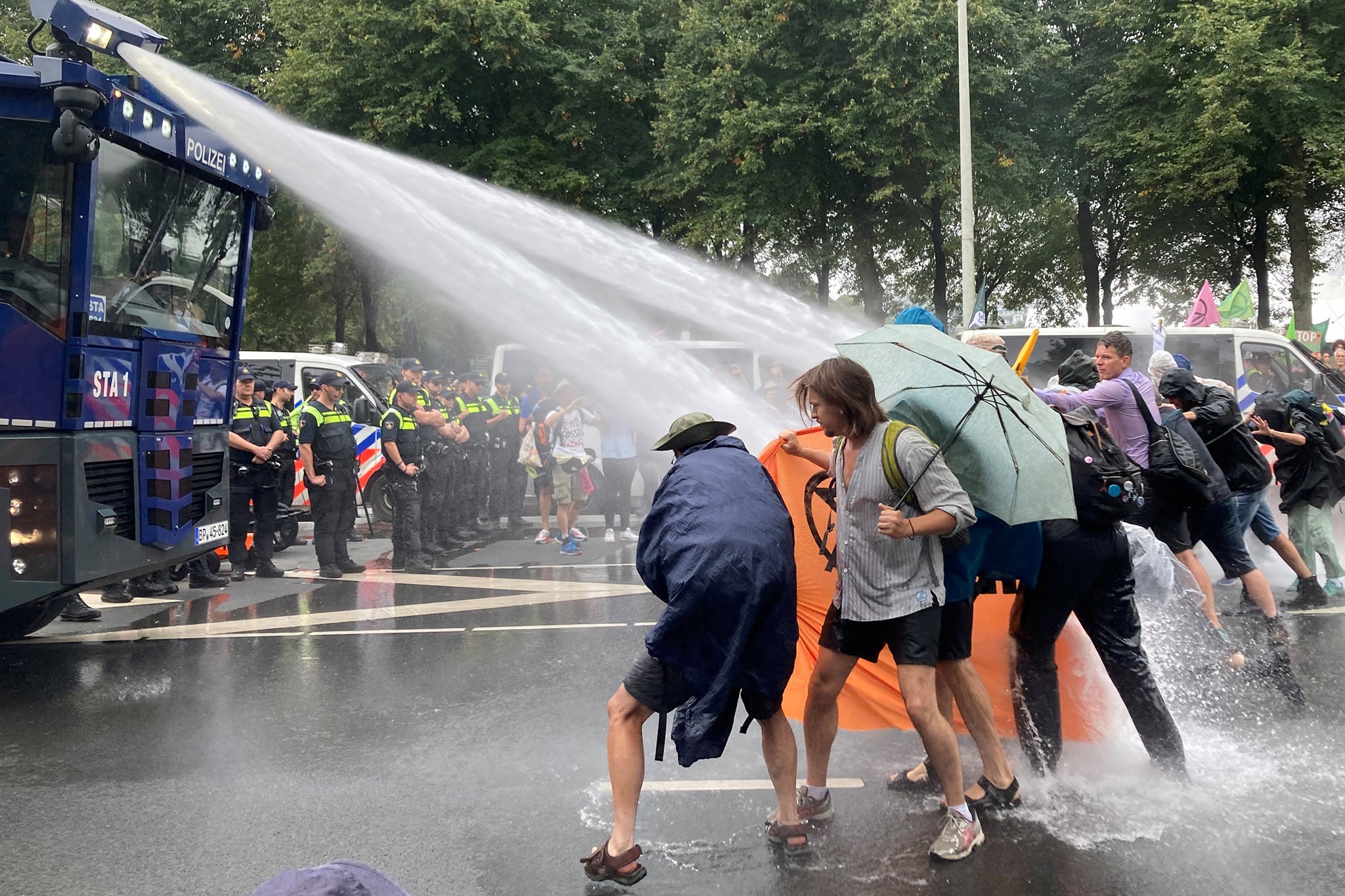 Dutch police uses water cannon to clear climate activists from the highway in The Hague, Netherlands