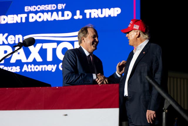 <p>Texas Attorney General Ken Paxton greets former U.S. President Donald Trump at the 'Save America' rally on October 22, 2022</p>