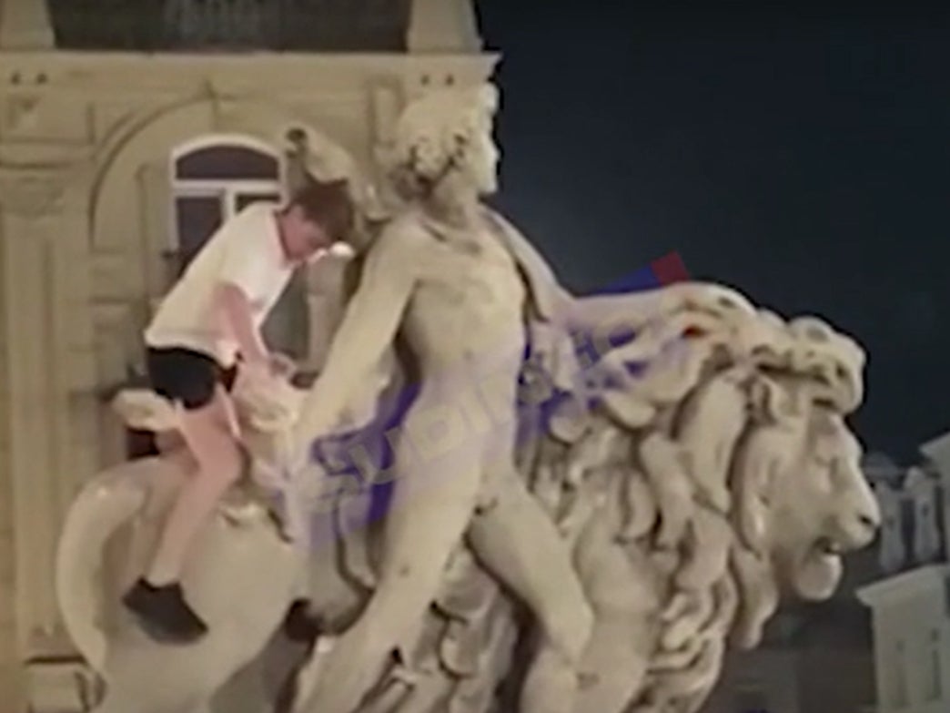 The man accidentally broke a piece off the statue while climbing on it