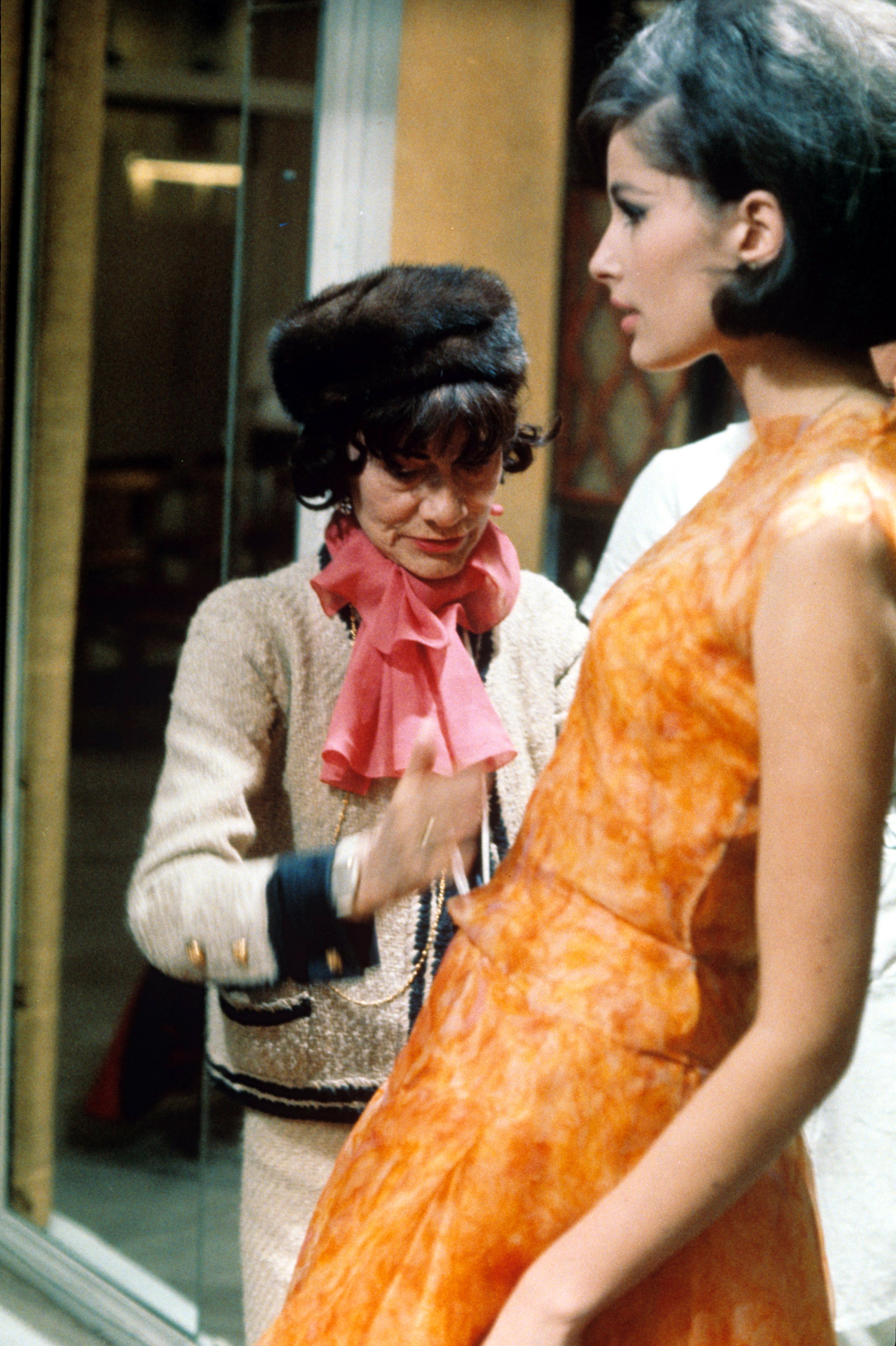 Chanel dresses a model following her fashion comeback in the Fifties
