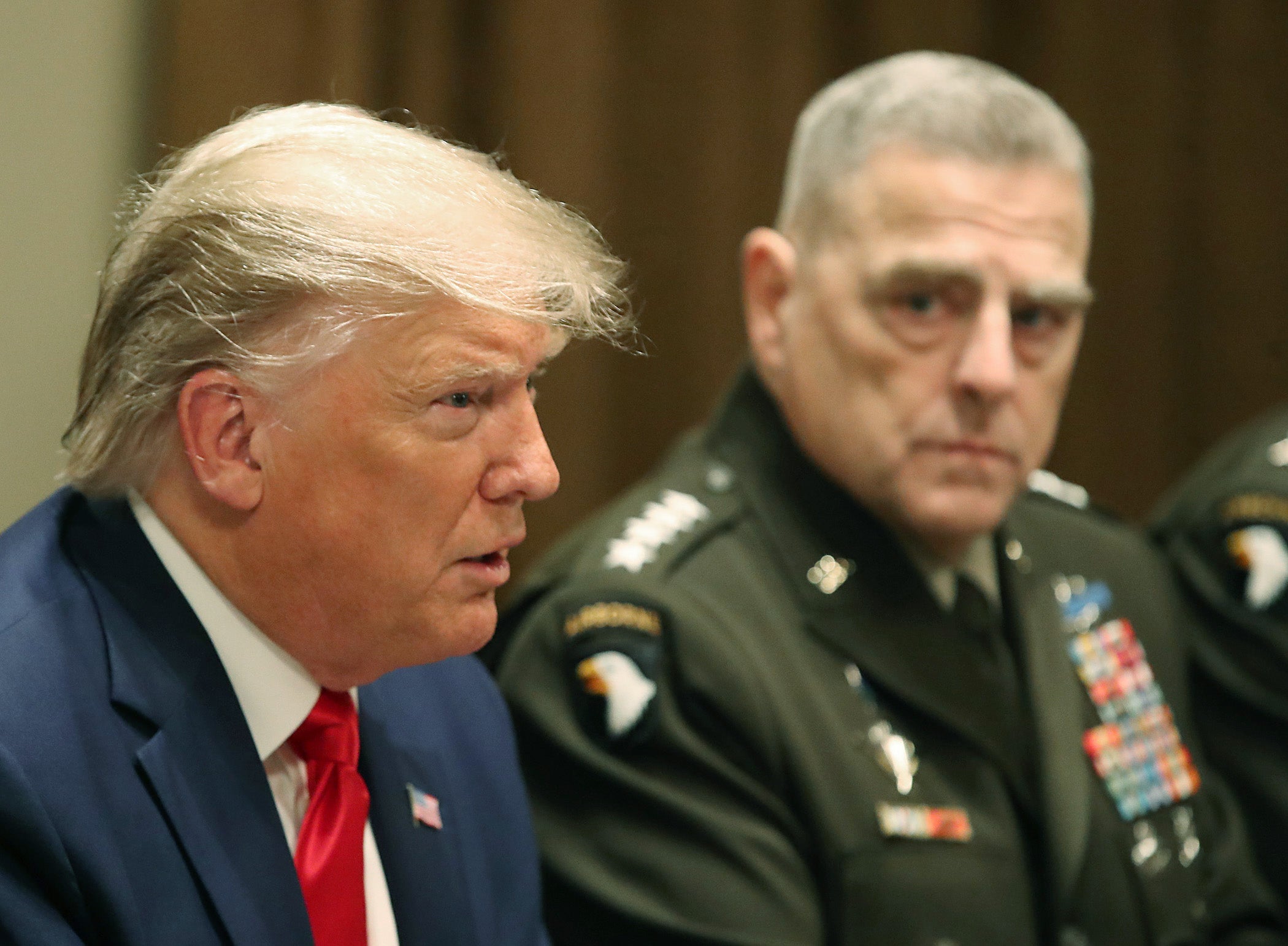 Donald Trump speaks as Joint Chiefs of Staff Chairman, Army Gen. Mark Milley looks on after getting a briefing from senior military leaders in the Cabinet Room at the White House on October 7, 2019 in Washington, DC.