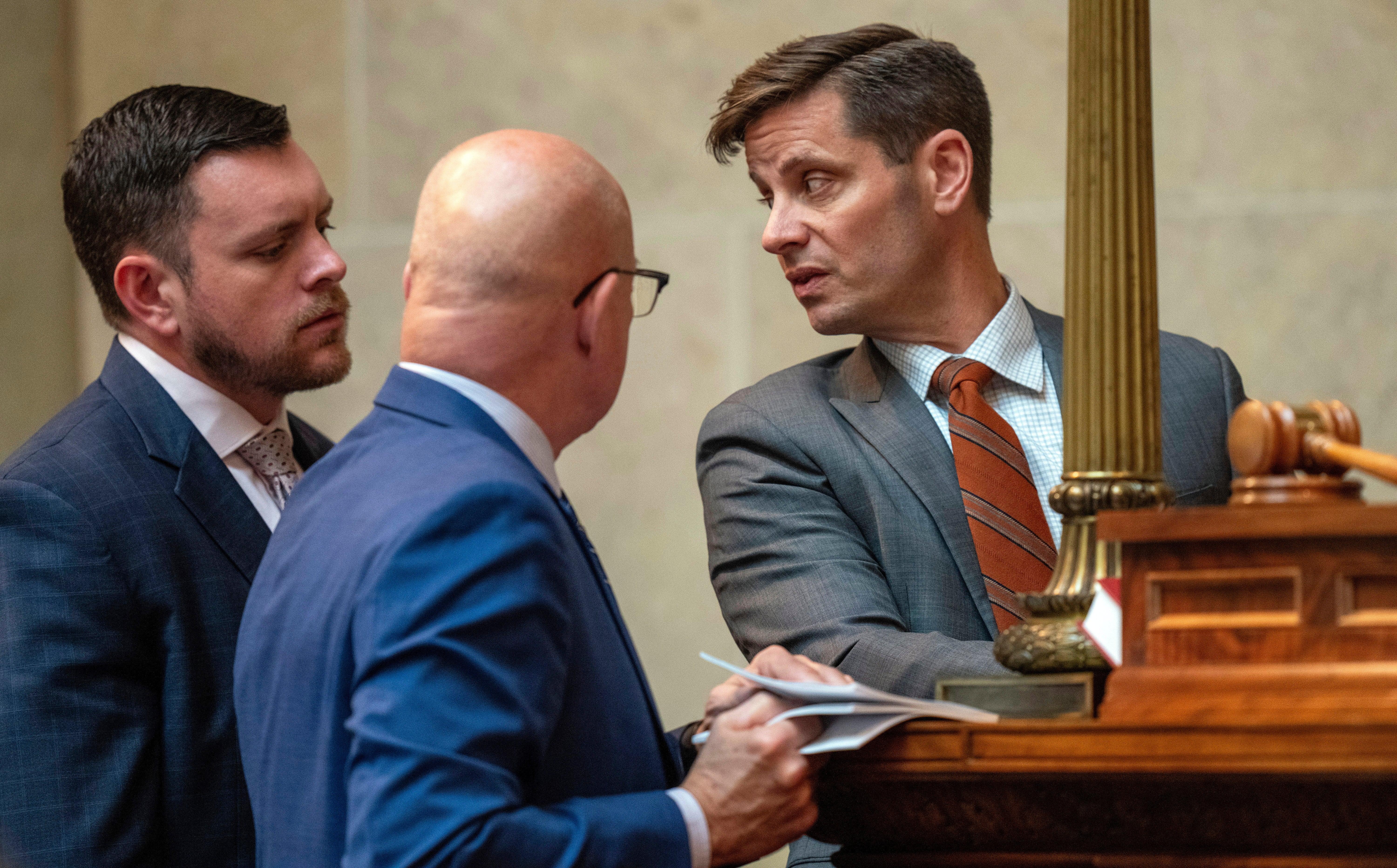 Wisconsin’s Republican Senate President Chris Kapena, right, speaks with lawmakers before a vote to fire Wisconsin Elections Commission administrator Meagan Wolfe on 14 September.