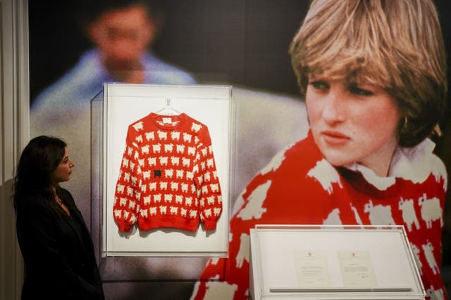 Nezha Bernoussi, marketing and communication associate at Sotheby’s looks at the late Diana, Princess of Wales’ black sheep jumper on display at Sotheby’s, central London, ahead of its sale as part of the auction house’s inaugural Fashion Icons sale in New York in September. The jumper, which she wore on several occasions, is estimated to sell for $50,000-$80,000 (�40,000-�70,000 pounds sterling), with online bidding open from August 31 to September 14. Picture date: Monday July 17, 2023.