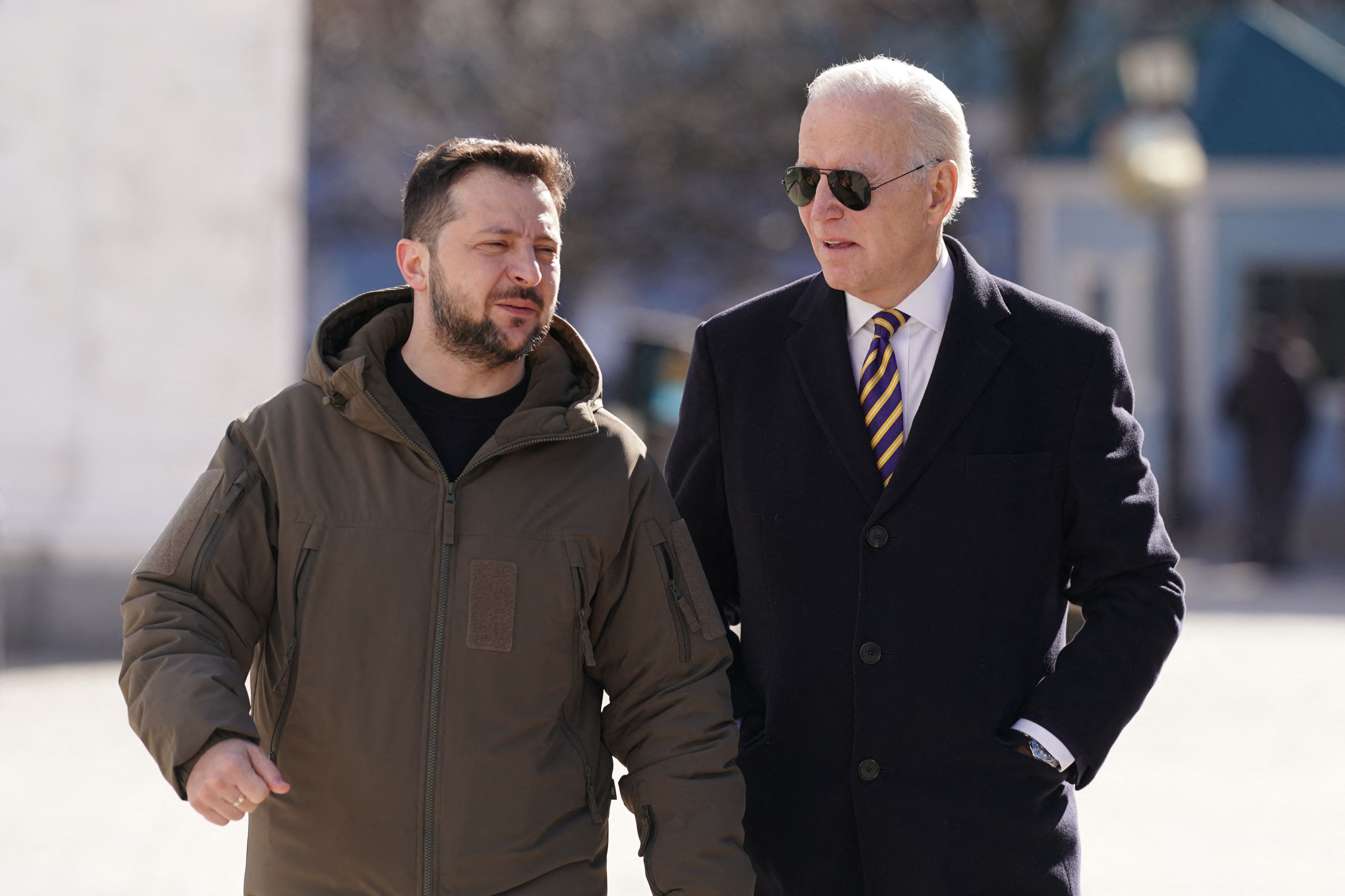 Joe Biden walks next to Ukrainian President Volodymyr Zelensky as he arrives for a visit in Kyiv