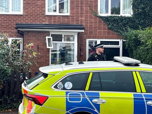 <p>A police officer outside a property in Main Street, Stonnall, Staffordshire,</p>