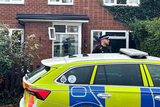 <p>A police officer outside a property in Main Street, Stonnall, Staffordshire,</p>