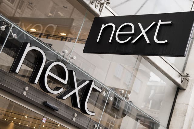 Fashion chain Next will give a glimpse into how the UK high street has fared this summer after a sunny June boosted sales (PA)