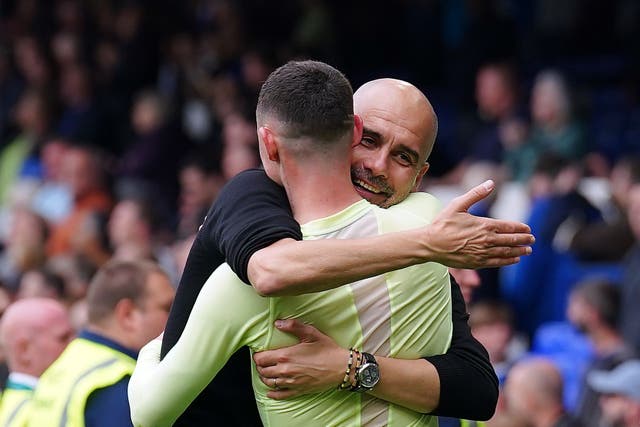 Manchester City manager Pep Guardiola and Phil Foden after the final whistle of the Premier League match at Goodison Park, Liverpool. Picture date: Sunday May 14, 2023.