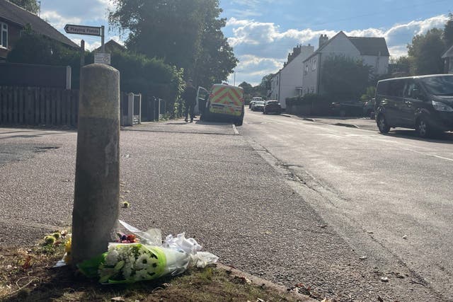 Floral tributes outside a property in Main Street, Stonnall, Staffordshire, after a man died after being bitten by two dogs (Matthew Cooper/PA)