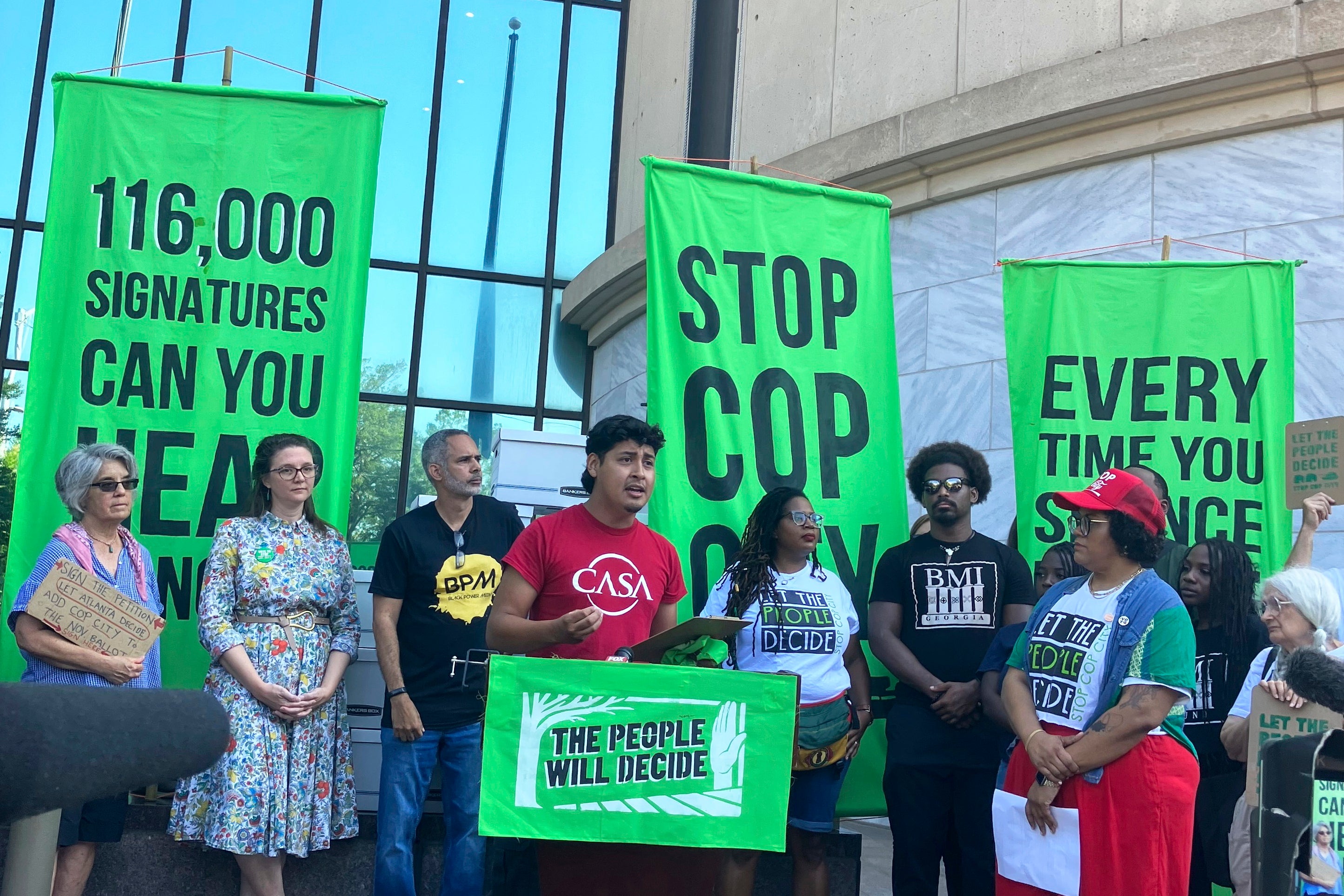 <p>Activists speak at a news conference outside Atlanta City Hall, on 11 September 2023</p>