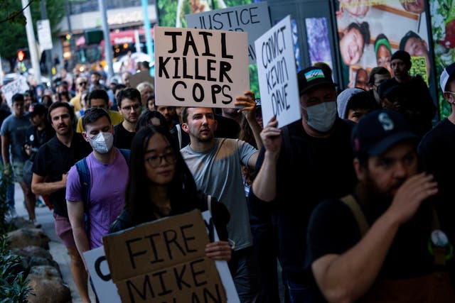 <p>Protesters march through downtown Seattle after body camera footage was released of a Seattle police officer joking about the death of Jaahnavi Kandula</p>