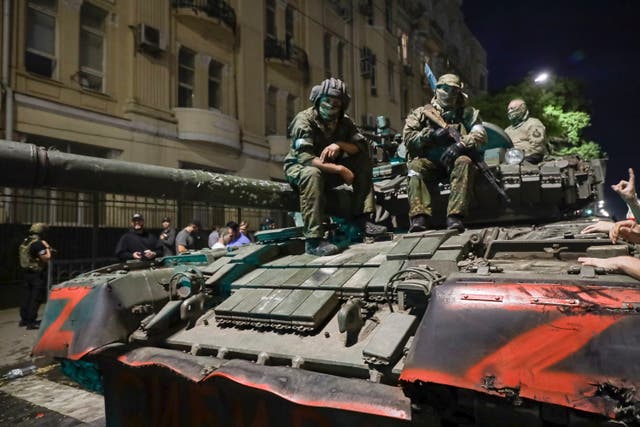 <p>Members of the Wagner Group military company sit atop of a tank on a street in Rostov-on-Don, Russia</p>