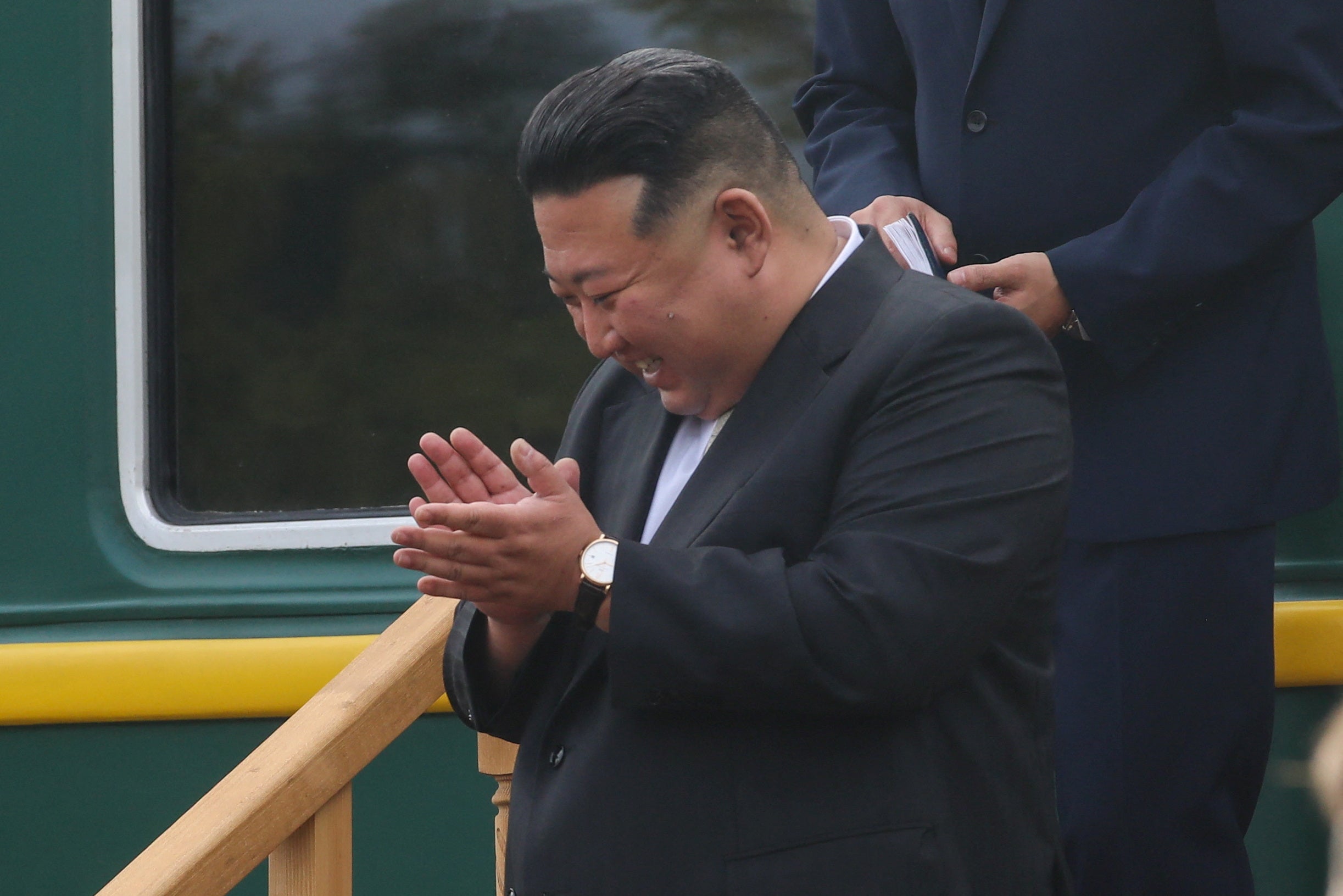 North Korean leader Kim Jong Un reacts during a welcoming ceremony upon his arrival at a railway station in the town of Artyom