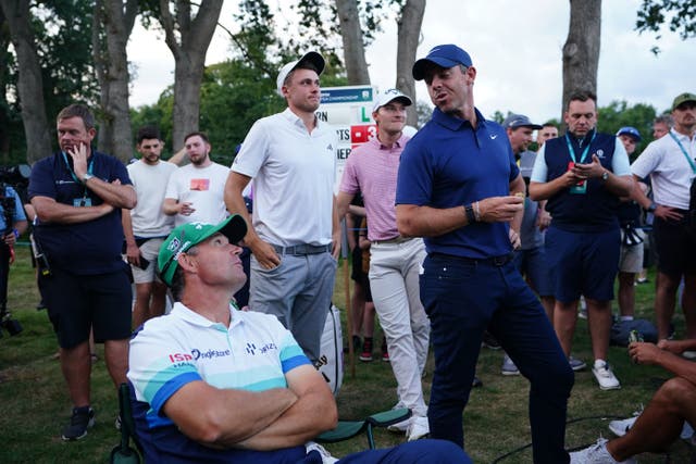 Rory McIlroy (right) waits for the 18th tee to clear with Padraig Harrington (seated) on day two of the BMW PGA Championship at Wentworth (Zac Goodwin/PA)