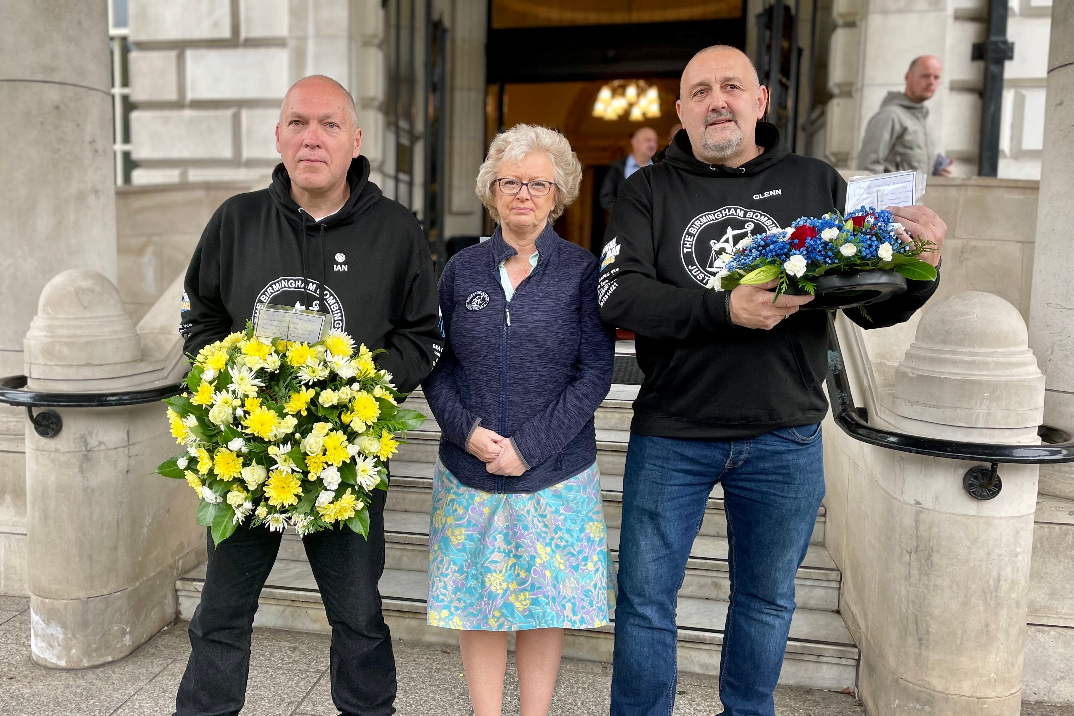 Ian Williams, Julie Hambleton and Glenn Randall outside Belfast City Hall (David Young/PA).