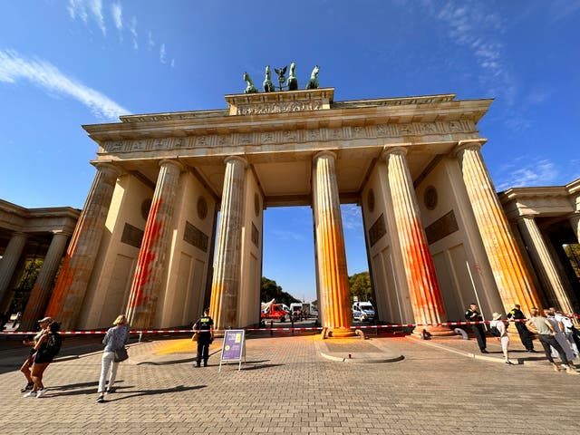 <p>Members of the climate protection group Last Generation have sprayed the Brandenburg Gate with orange paint in Berlin, Germany</p>