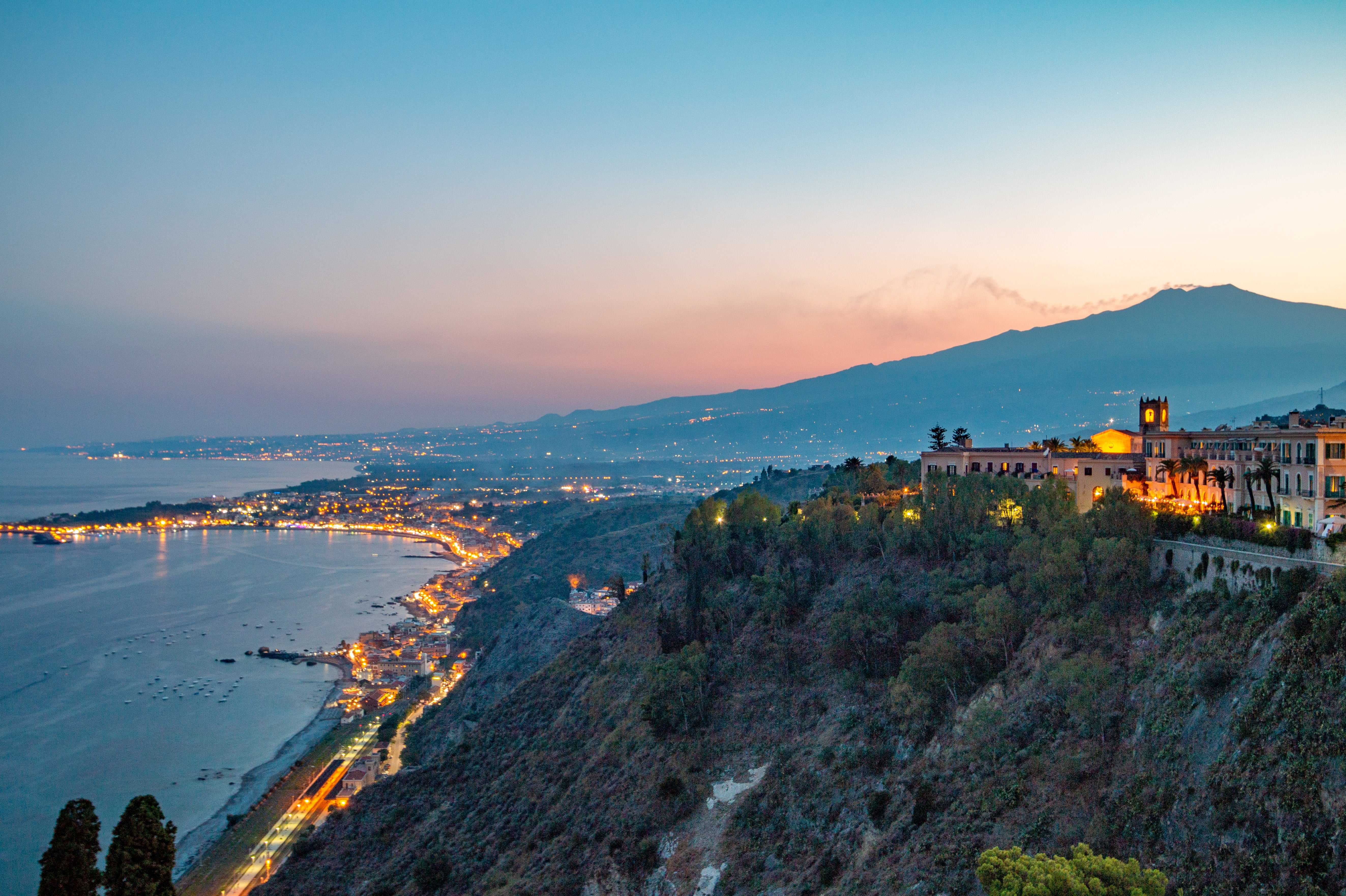 Mount Etna in Province of Catania, Sicily, with Taormina in the foreground