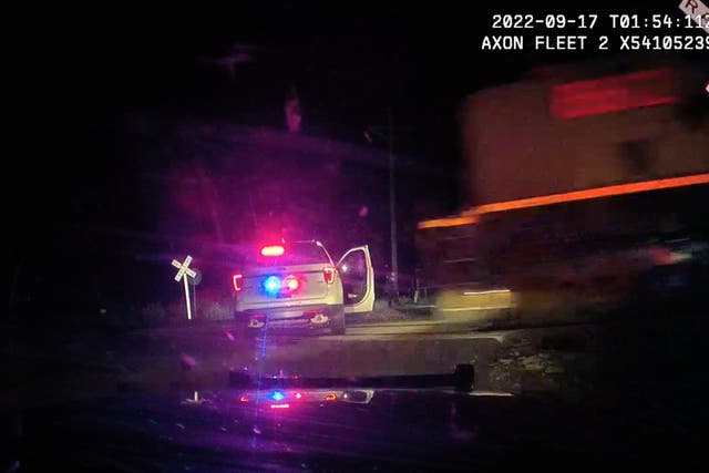 <p>This screengrab from dash camera video provided by the Fort Lupton Police Department shows a freight train barreling toward a parked police car with a suspect inside, 16 September 2022, in Fort Lupton, Colorado </p>