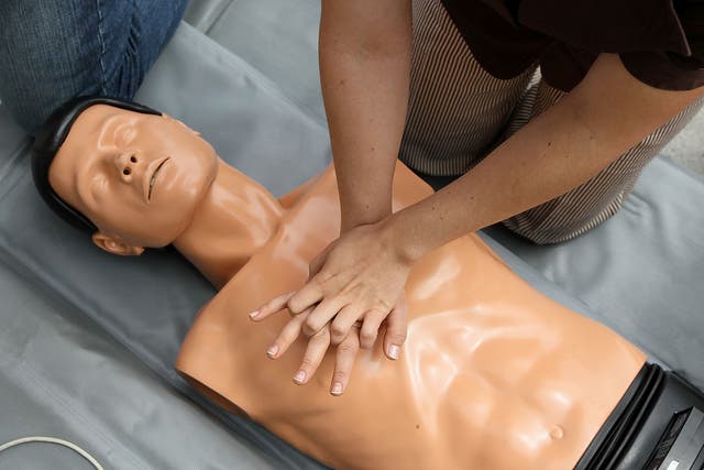 <p>A woman performs chest compressions on a mannequin while learning C.P.R. on the steps of San Francisco city hall following a press conference celebrating the 50th anniversary of lifesaving by using C.P.R. June 1, 2010 in San Francisco, California</p>