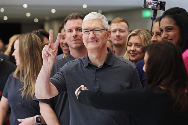 <p>Apple CEO Tim Cook looks at brand new Apple products during an Apple event on 12 September 2023 in Cupertino, California</p>