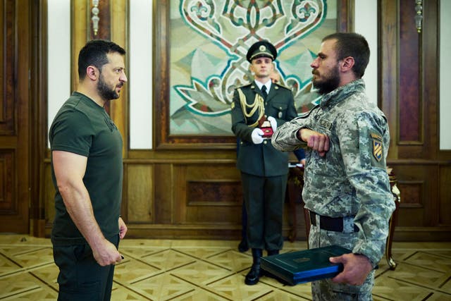 <p>In this handout photograph taken and released by Ukrainian Presidential Press Service on September 14, 2023 Ukraine’s President Volodymyr Zelensky (L) gives an award to a serviceman during a ceremony marking Tank Troops Day in Kyiv</p>