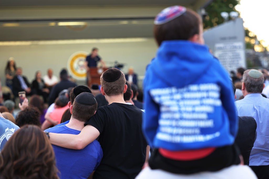 People listen to Joseph Borge speak during a rally denouncing antisemitic violence in May 2021 in Cedarhurst, New York