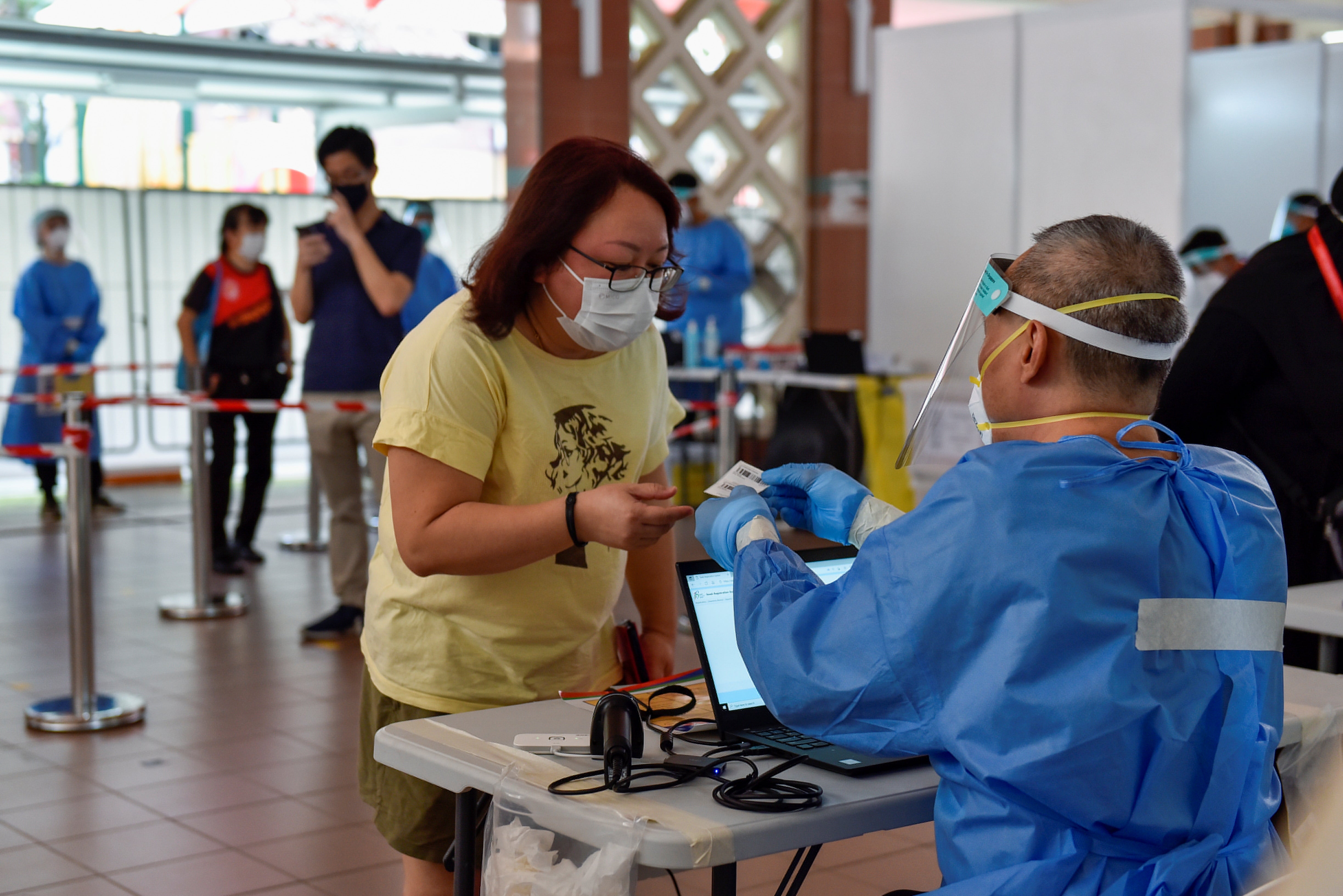 <p>File: Swab tests are conducted at a public housing estate after a nearby food centre became a Covid-19 cluster in Singapore</p>