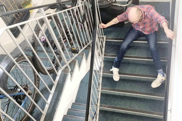 Chris Purnell dragging himself down the stairs of his block of flats in Granton, Edinburgh.