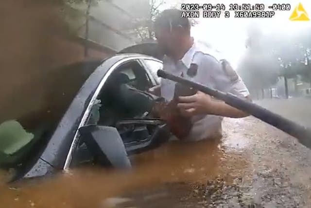 <p>Trapped driver in flooded car rescued in dramatic police bodycam footage. </p>