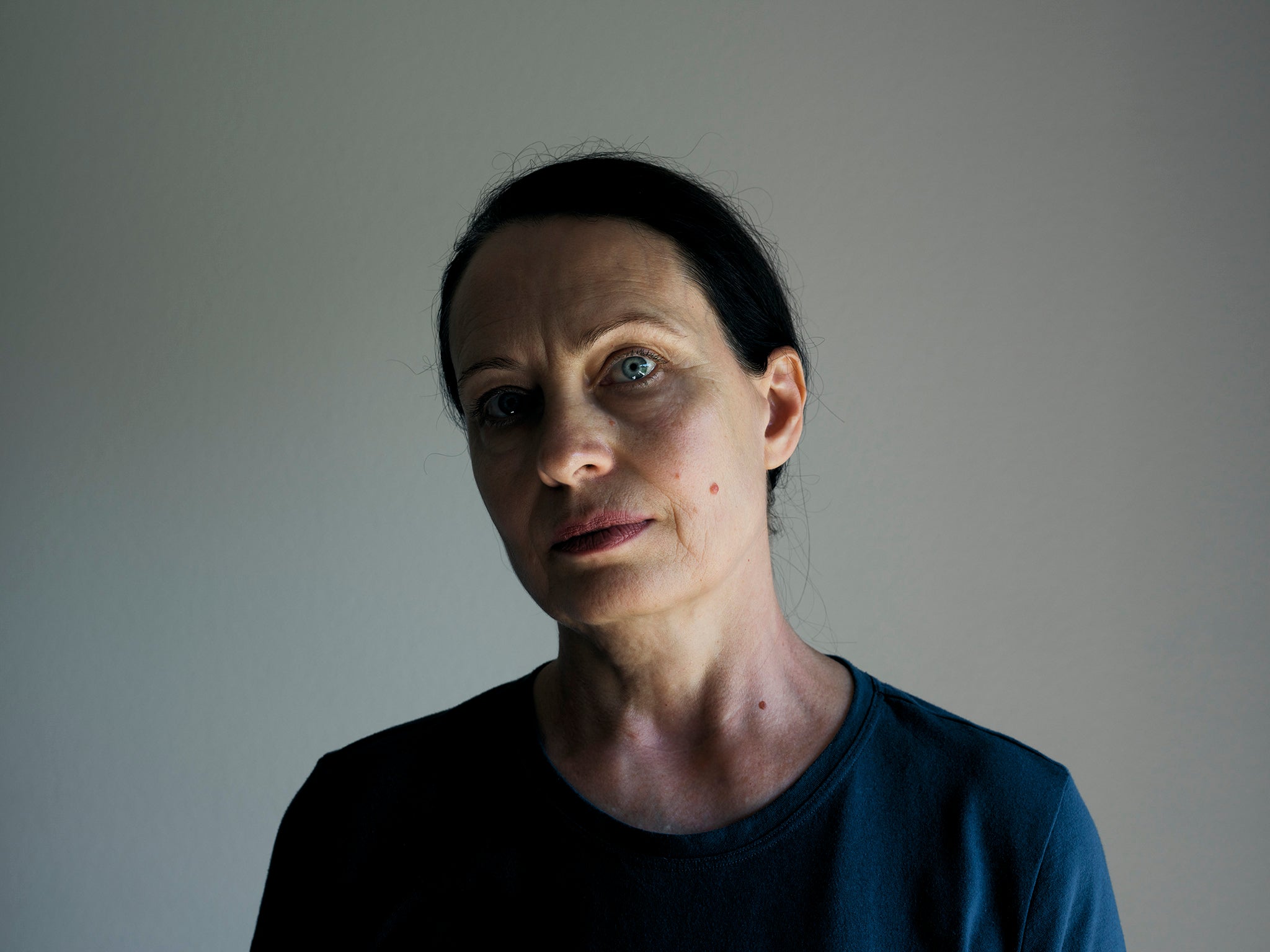 Lydia, 55, from Kherson, stands in her bedroom at the Swiss convent