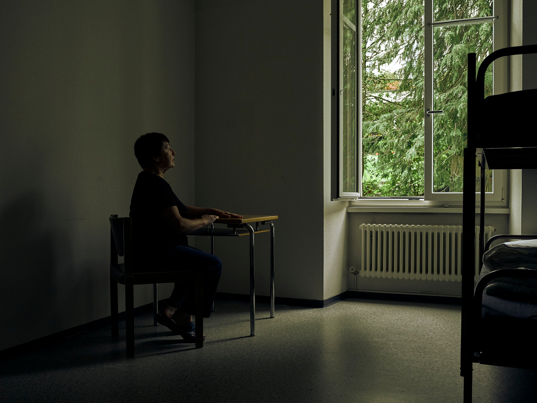 Olga, 67, from Sumy in Ukraine, seated in a bedroom at Kloster Menzingen, a monastery nestled in the rolling hills of canton Zug, Switzerland