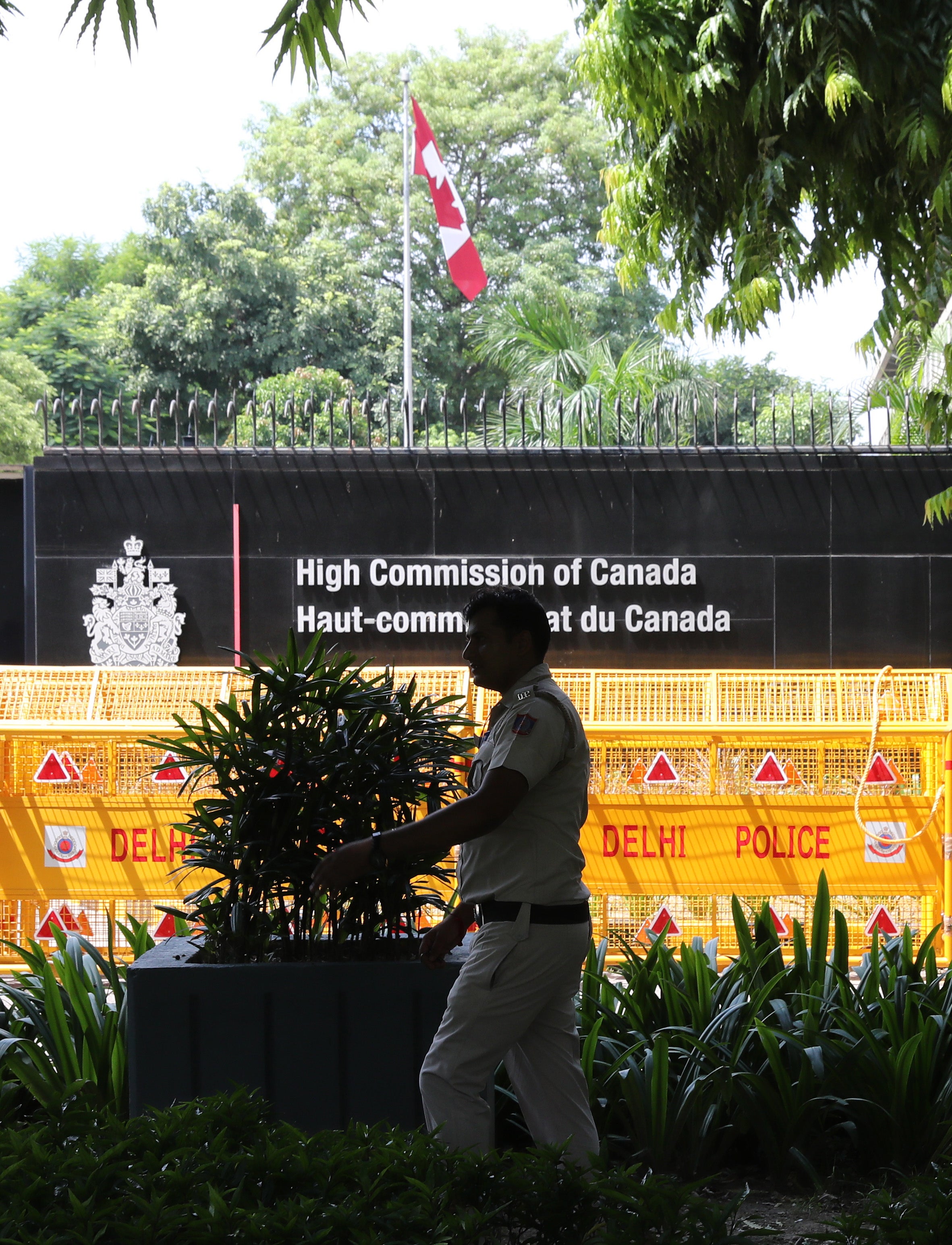 An Indian policemen patrols in front of the Canadian embassy in New Delhi