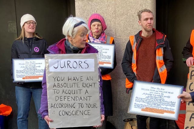 Trudi Warner from Walthamstow, east London, and supporters holding up signs outside the Old Bailey (PA)