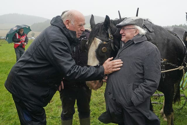 President Michael D Higgins meets competitors L-R James Gorry and John Kelly at the horse section during the National Ploughing Championships (Niall Carson/PA)