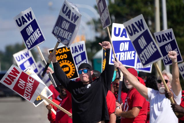 <p>United Auto Workers members walk the picket line at the Ford Michigan Assembly Plant in Wayne, Michigan on 18 September. </p>