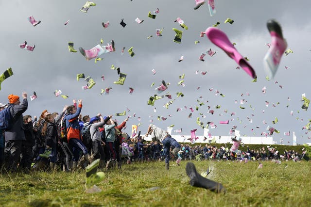 People take part in a Guinness World Record attempt at the most people throwing wellies. (PA)