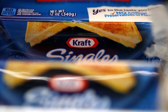 <p>Packages of Kraft Singles are displayed on a grocery store shelf on February 22, 2019 </p>