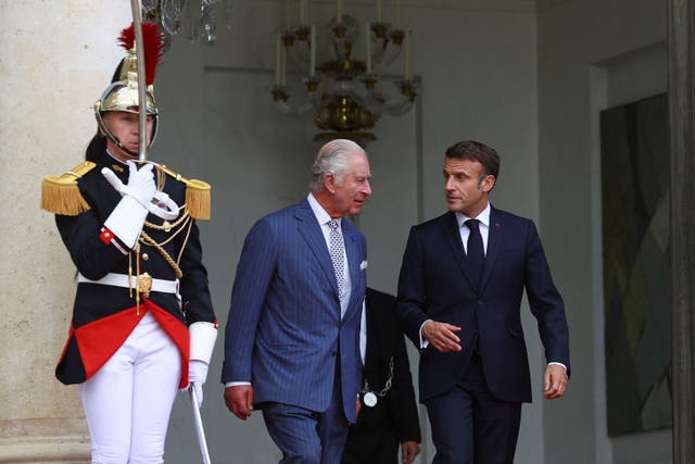 <p>The King walks with French President Emmanuel Macron at the Elysee Palace (Hannah McKay/PA)</p>