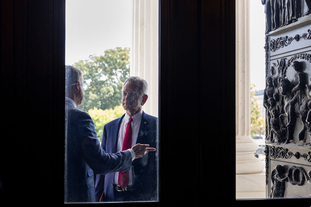 Sen Tommy Tuberville speaks to a colleague on Capitol Hill