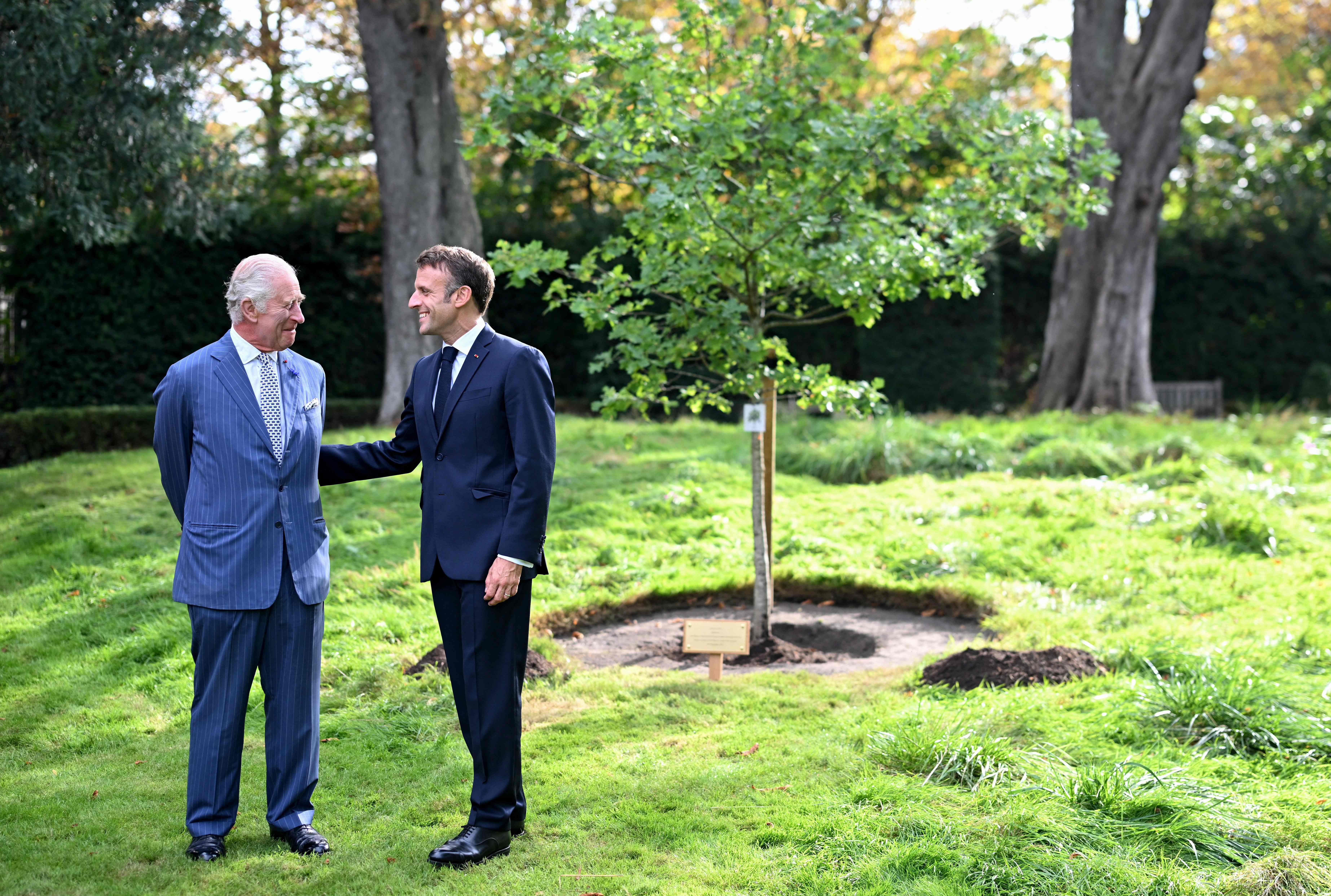 Britain’s King Charles III (left) and French President Emmanuel Macron take part in an oak tree planting ceremony to commemorate the visit in the garden of the British Ambassador’s residence in Paris