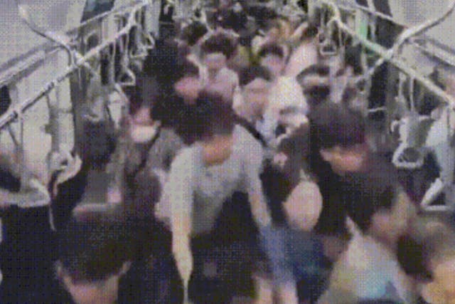 <p>Security footage shows a stampede that occured after a man pushed his way through a subway train, sparking fears of a mass stabbing and injuring at least 21 people</p>