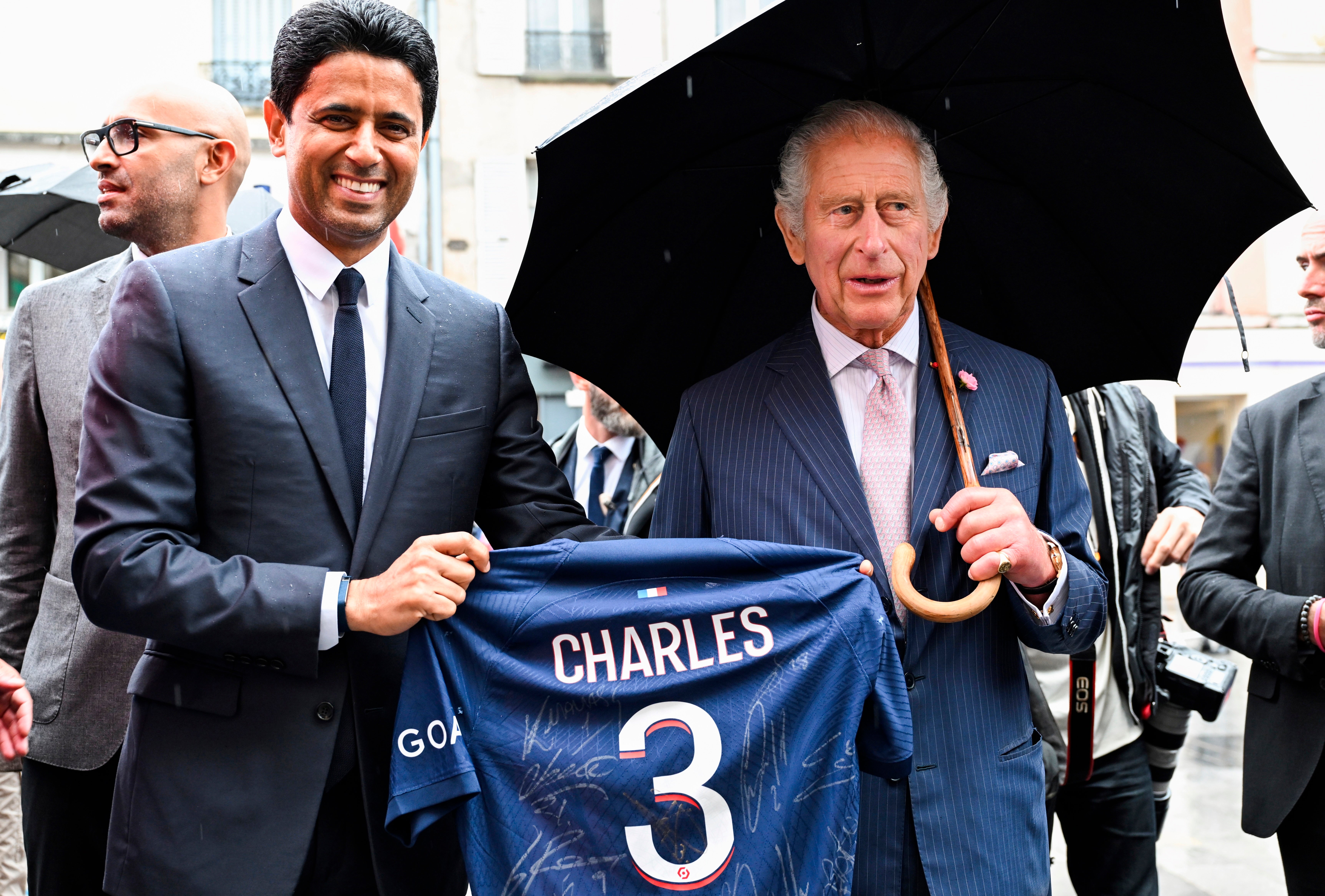 Paris Saint Germain's president Nasser Al-Khelaifi offers Charles a PSG jersey on Thursday in Saint-Denis