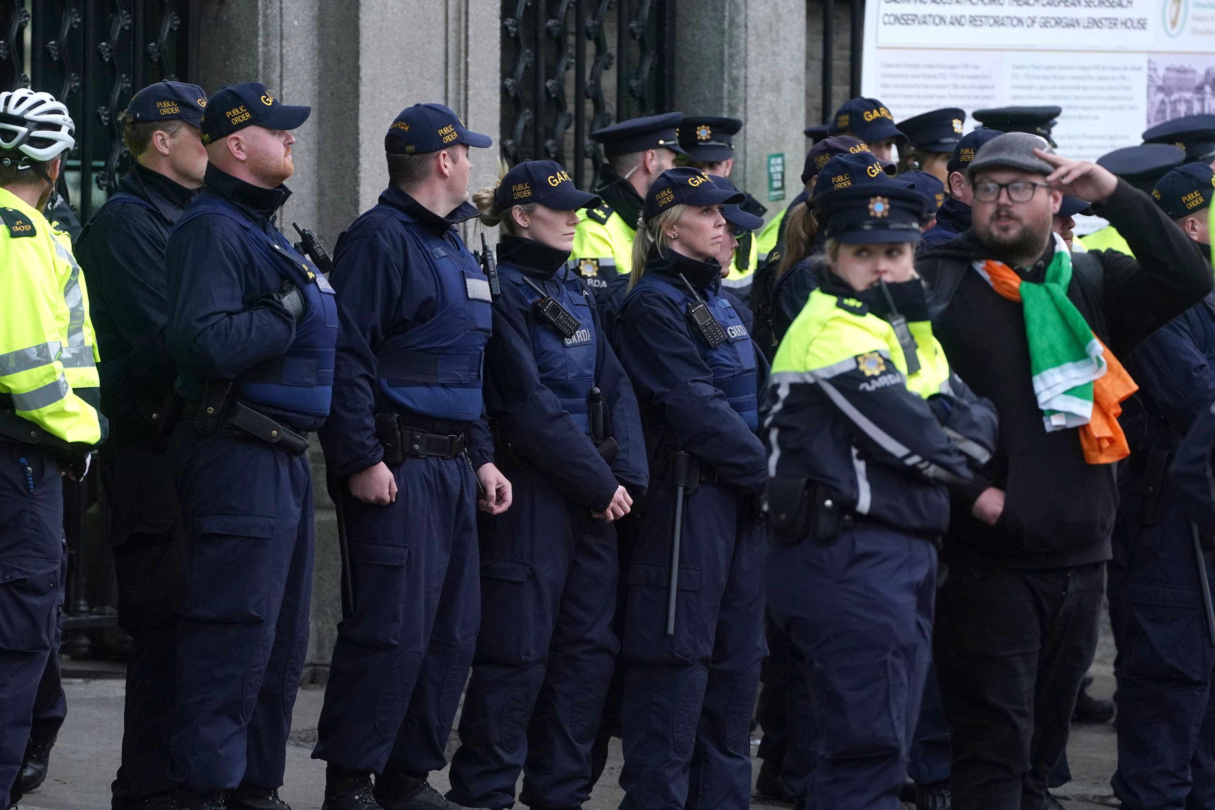 Members of the Garda Public Order Unit watch protesters outside Leinster House (Brian Lawless/PA)