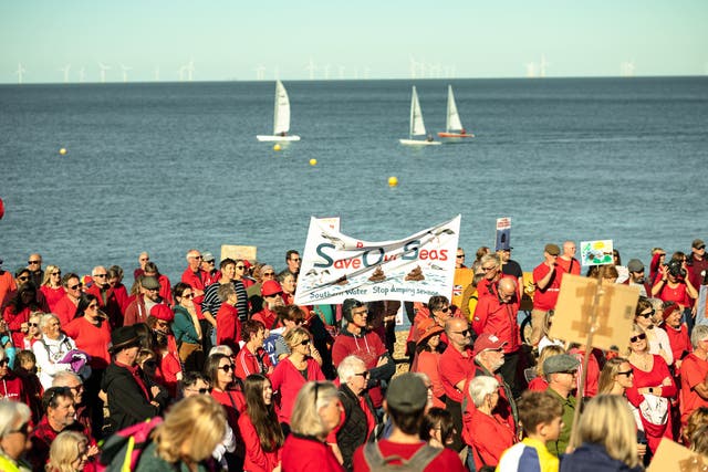 Campaigners and protesters against sewage pollution at a previous SOS Whitstable protest in 2022 (Aga McPherson/PA)