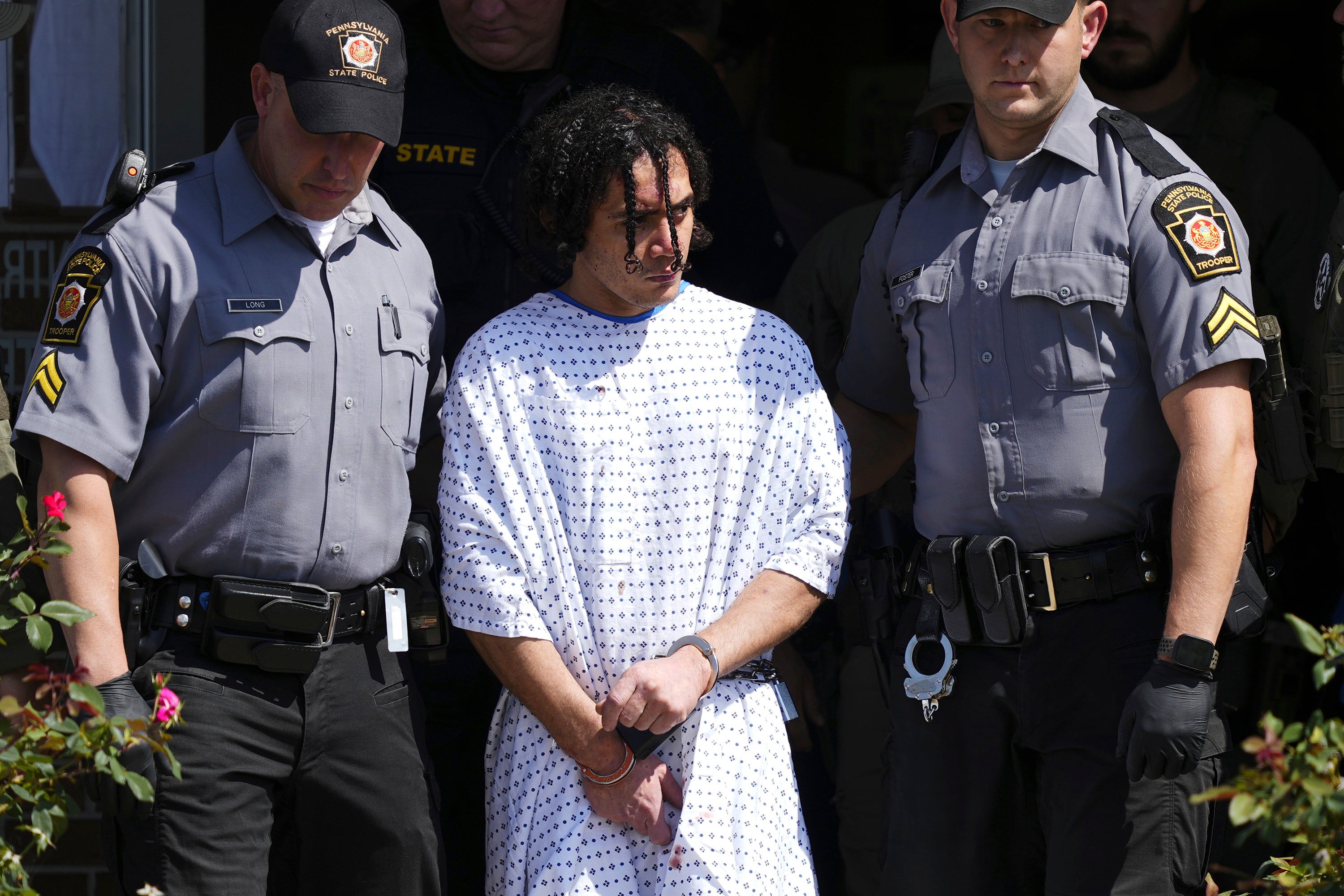 Law enforcement officers escort Danilo Cavalcante from a Pennsylvania State Police barracks in Avondale, Pa