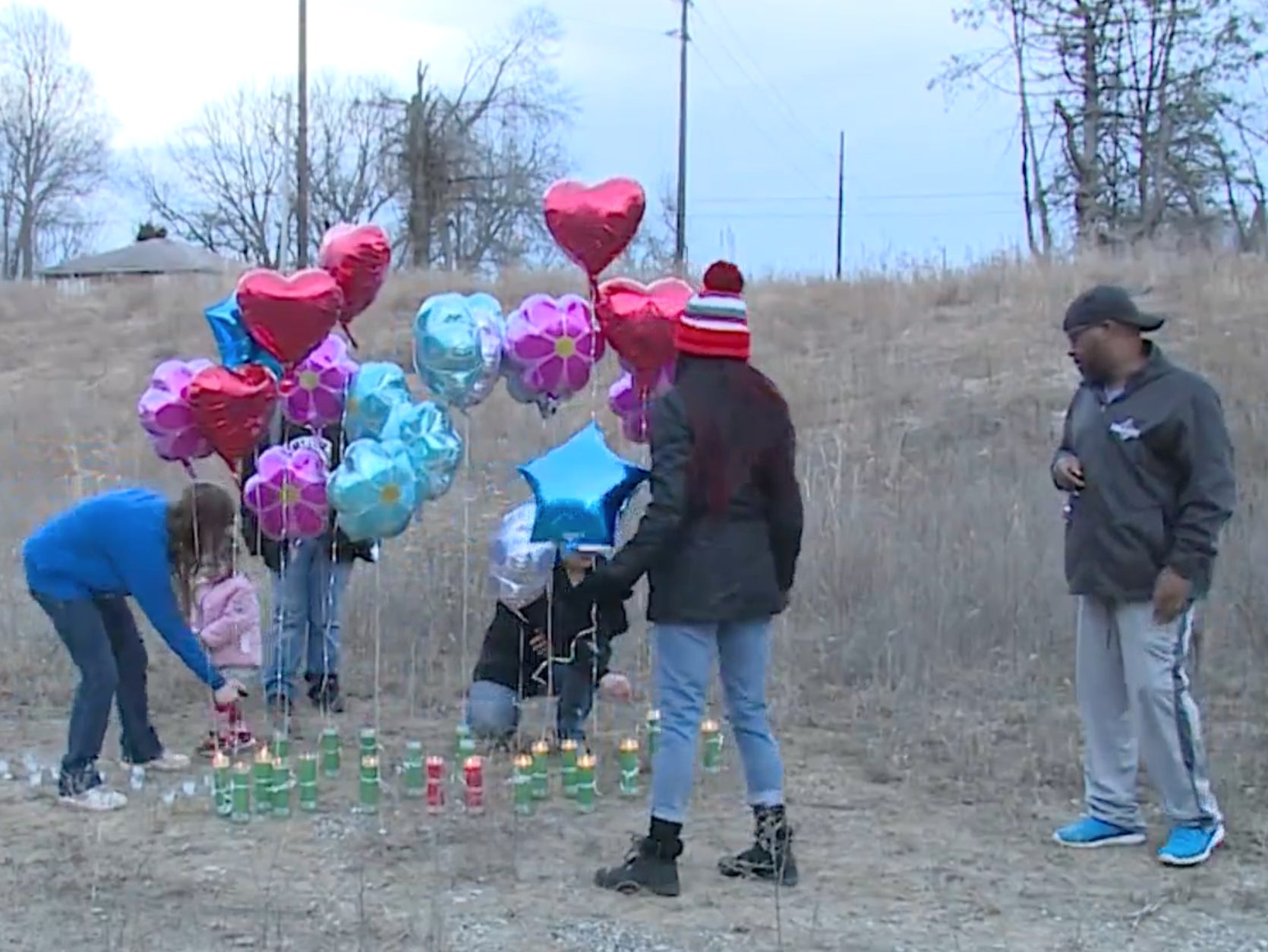The family of Christina King, who was murdered in 1998, gather in Kansas City in 2021 to place candles and balloons in her memory