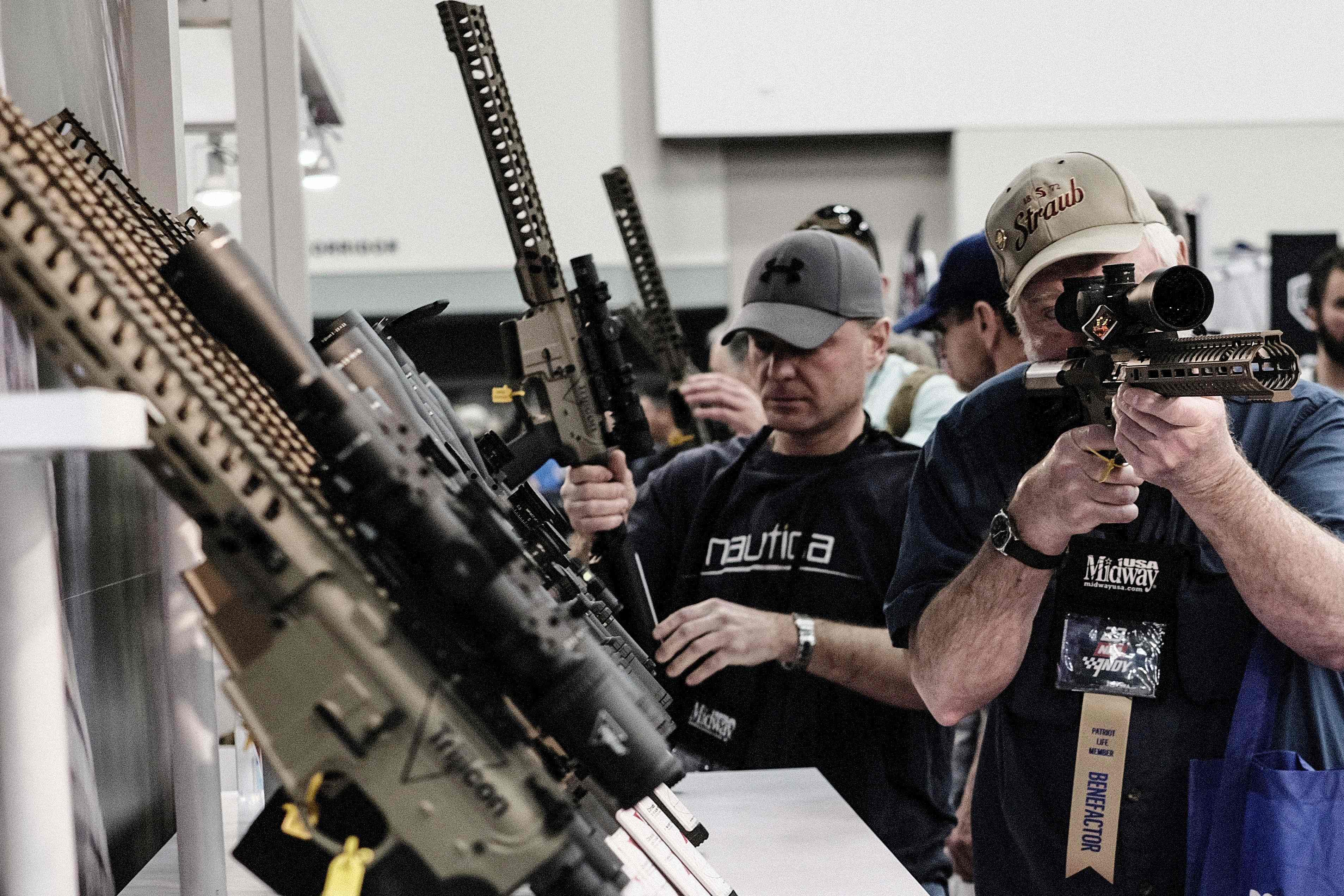 National Rifle Association convention guests inspect rifles in Indiana on 14 April, 2023.