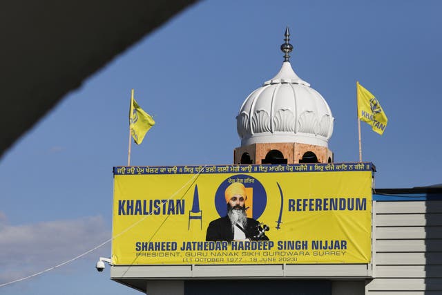 <p>A banner with the image of Sikh leader Hardeep Singh Nijjar is seen at the Guru Nanak Sikh Gurdwara temple, site of his June 2023 killing, in Surrey, Canada </p>