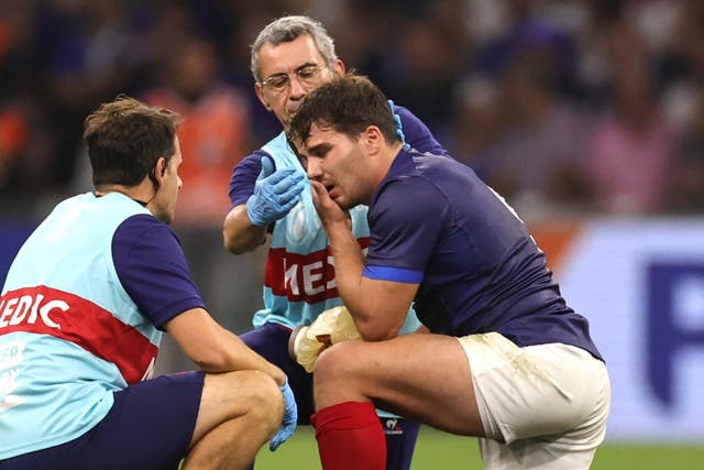 <p>Antoine Dupont, the France captain, receives treatment following head contact with Johan Deyselduring</p>