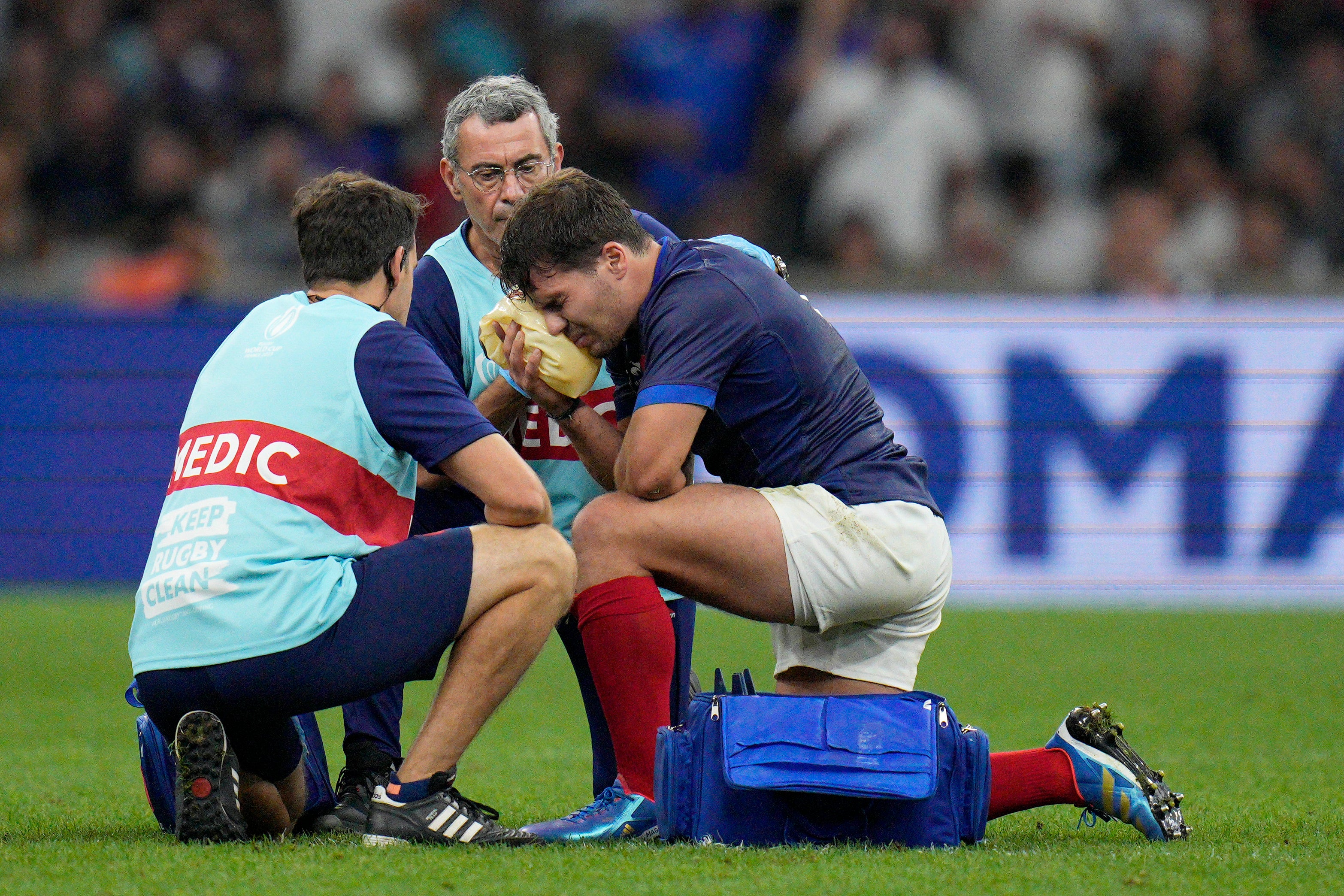 France’s Antoine Dupont receives treatment after taking a knock to the head